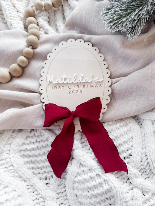 scalloped oval babies first christmas sign with bow