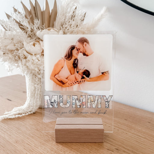 Freestanding Photo Plaque holding a photo of a female/male couple holding a new born baby. The plaque states Mummy I love you to the moon and back