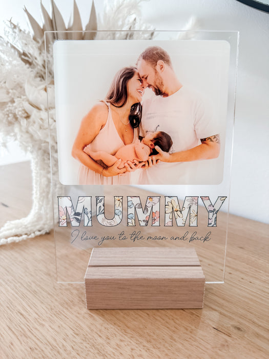 Freestanding Photo Plaque holding a photo of a female/male couple holding a new born baby. The plaque states Mummy I love you to the moon and back