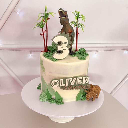 Dinosaur themed birthday cake topper with child age and name