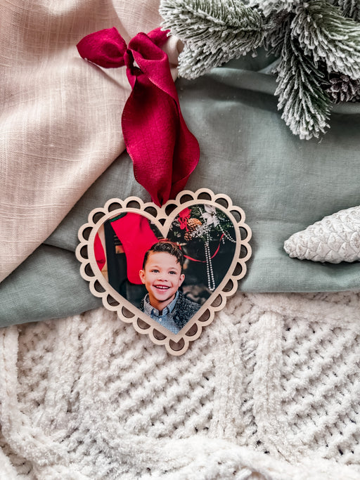 Personalised heart shaped photo christmas tree ornament with red bow and scalloped detail