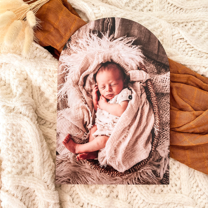 Photo of a swaddled baby on an arch shaped photo block for a mothers day gift