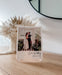 Close up wedding Anniversary photo plaque for valentines day. Sitting on wooden bench with clear acrylic display stand.