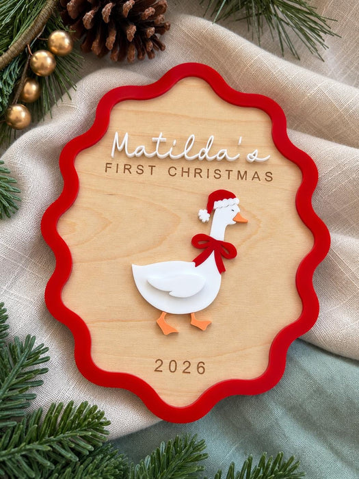 Close up of the layered acrylic goose with a red bow and Santa hat on the first Christmas sign