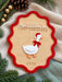 Close up of the layered acrylic goose with a red bow and Santa hat on the first Christmas sign