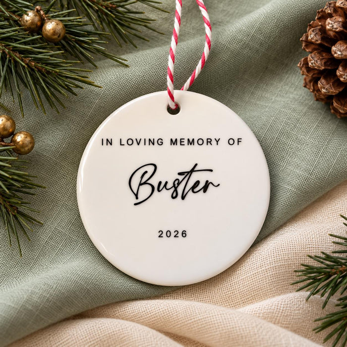 Back of the ceramic bauble reading In Loving Memory Of Buster 2026 in black lettering