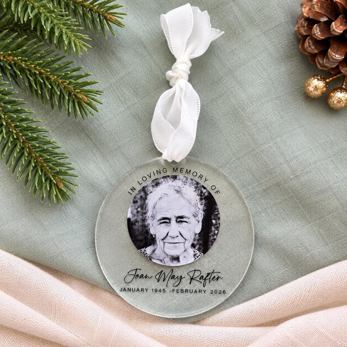 Clear acrylic bauble with a black and white photo of Joan May Rafter and a white ribbon