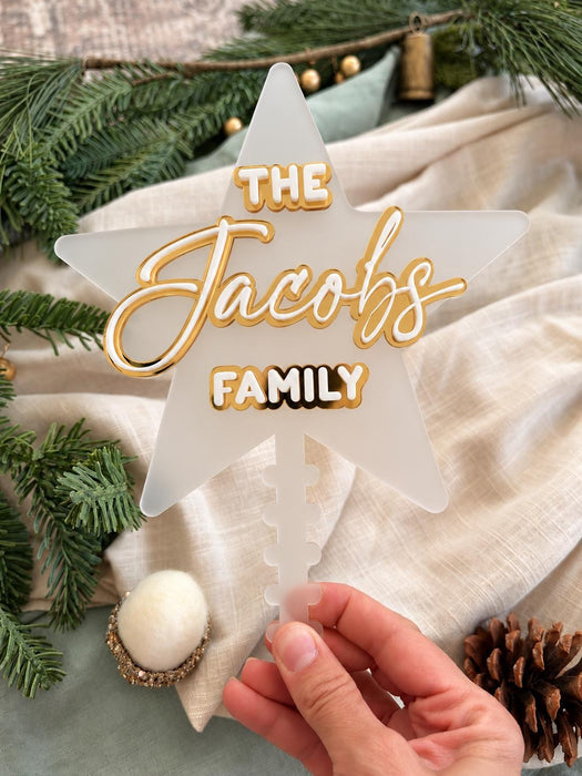 Close up of The Jacobs Family in gold mirror and white acrylic on the frosted star, styled with pine