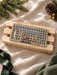 Christmas crate sign in green gingham acrylic reading A special delivery for Oliver in gold mirror, on a wooden crate