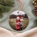 Christmas 2026 ornament in glossy white ceramic with a photo of two children in Santa hats and Christmas jumpers hugging
